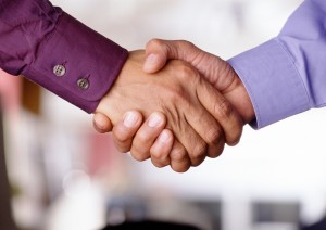 Two men shake hands