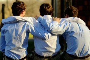 A group of friends with their arms around each other.