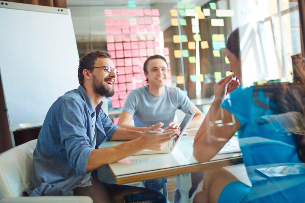 Three business owners sit around a table, creating a business plan