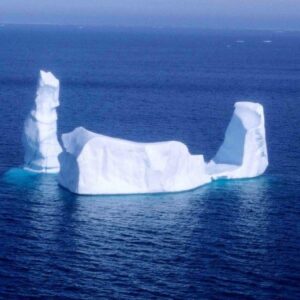 An iceberg floats in a lonely ocean