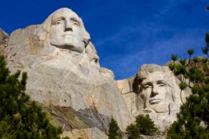 A photo of Mt. Rushmore depicts the law of buy-in