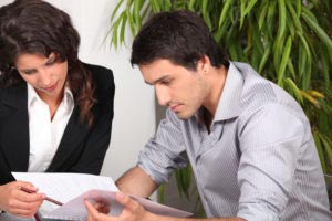A lawyer and a business client meet to depict how to choose a lawyer for your business.
