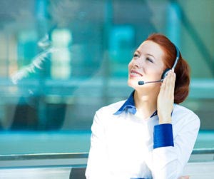 A woman salesperson with a headset uses a sales script when selling.