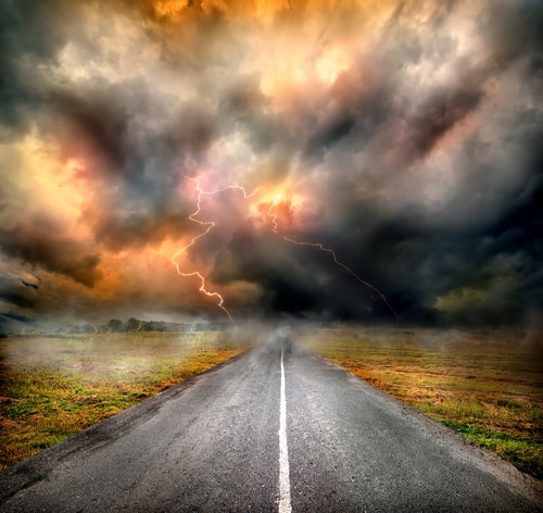 A thunderstorm over a two lane highway depicts Dealing with Conflict