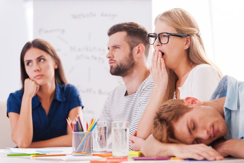 Four conference call attendees yawn, depicting an ineffective conference call.