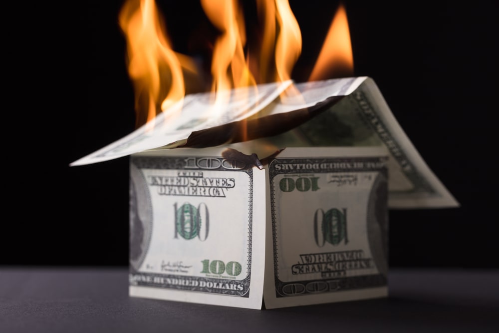 value-based pricing strategy is depicted by a house built of currency burns