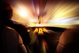 A photo of a driver looking at a warp speed vision in the window