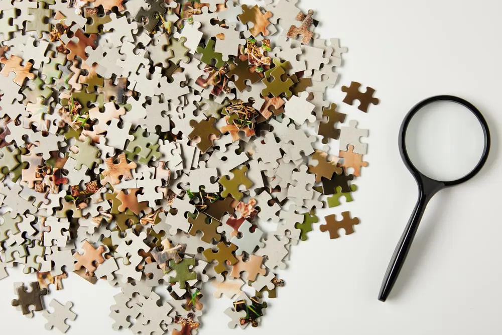 A table full of puzzle pieces signifying a complex problem faced by a small business