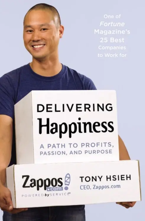 Tony Hsieh the author of Delivering Happiness is holding Zappos boxes