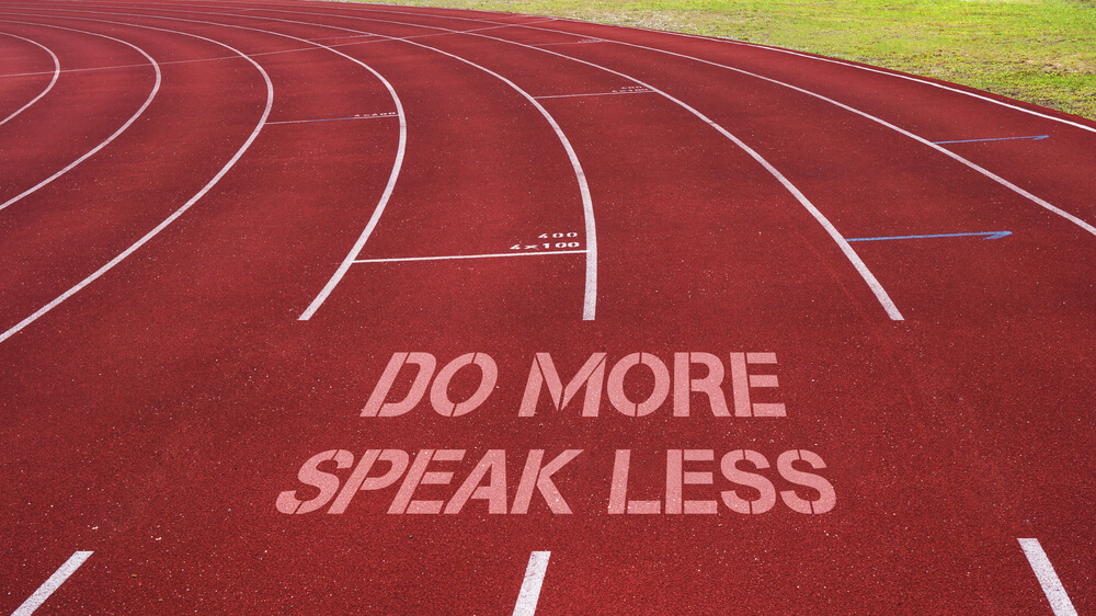 a photo of a running track with the words do more, speak less on the track