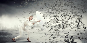 A woman executive holds an umbrella against the storm of competing activities