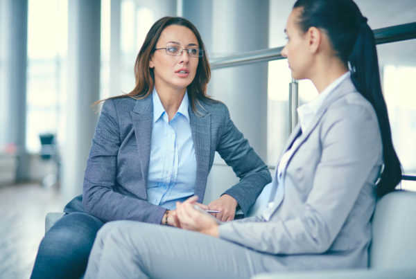 A professional woman manager confronts an employee and has a difficult conversation.