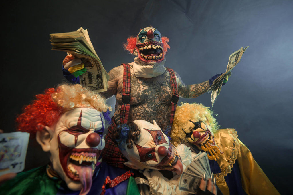Four scary clowns hold cash like money-grubbing businessmen