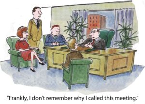 Five people meet around their boss's desk, depicting poor meeting planning.