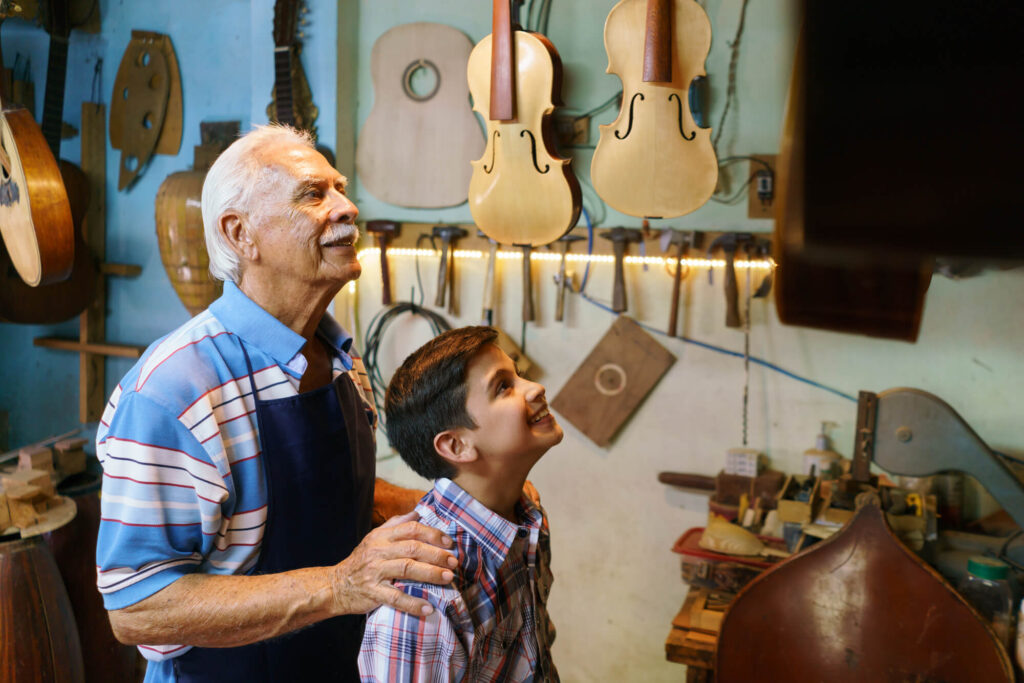 A grandfather teaches his grandson about his music store business.