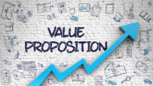 The words value proposition are written on a brick wall that contains an upward sloping graph