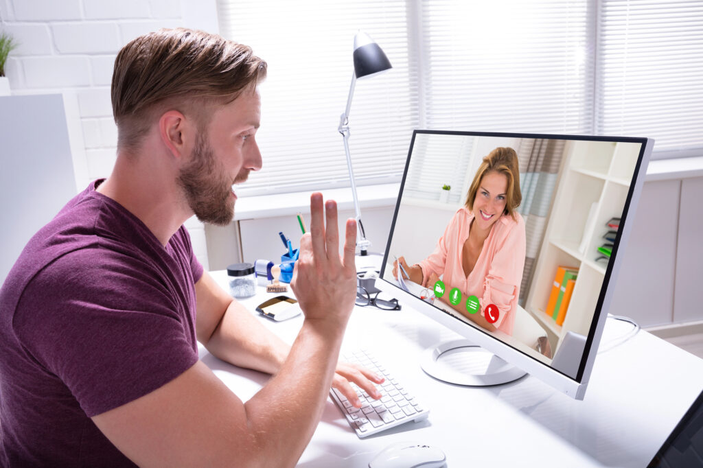 A business owner meets with his coach on a video call