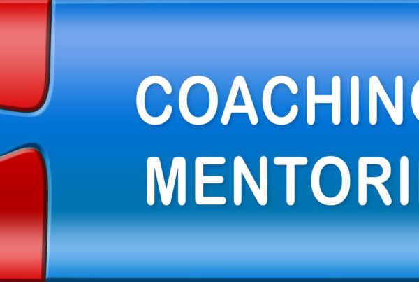 Two interlocking puzzle pieces that read coaching and mentoring