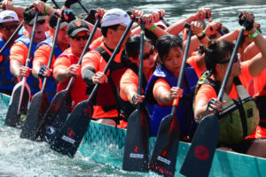 A photo of dozens of rowers in a boat showing a resilient culture