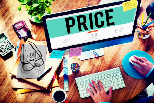 A graphic that shows a messy desk with a monitor that says "price".