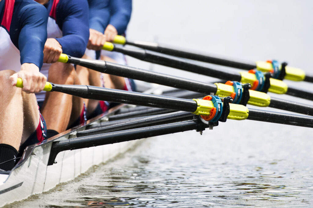 a photo of four rowers in a competitive rowing boat