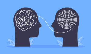 A drawing of two human skulls with a stream of information between the two
