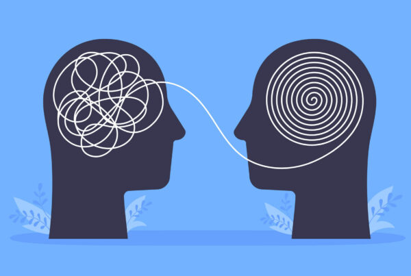 A drawing of two human skulls with a stream of information between the two