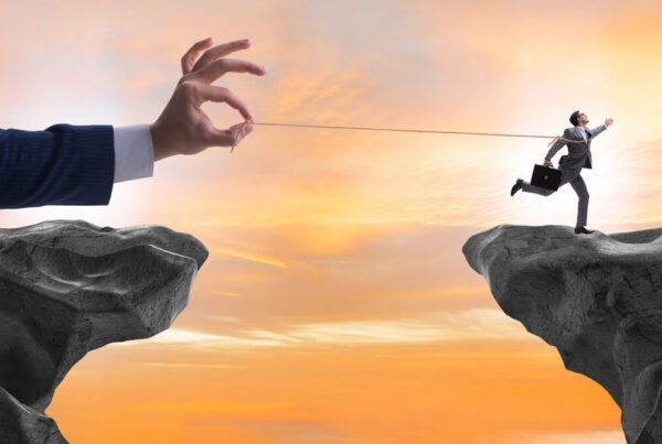 A giant hand pulls on the string that is tied to a running employee