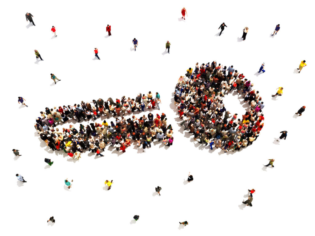 Hundreds of people gather to form the image of a key.