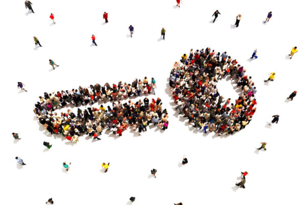 Hundreds of people gather to form the image of a key.