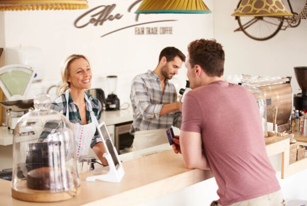 Three business owners work with their local customers