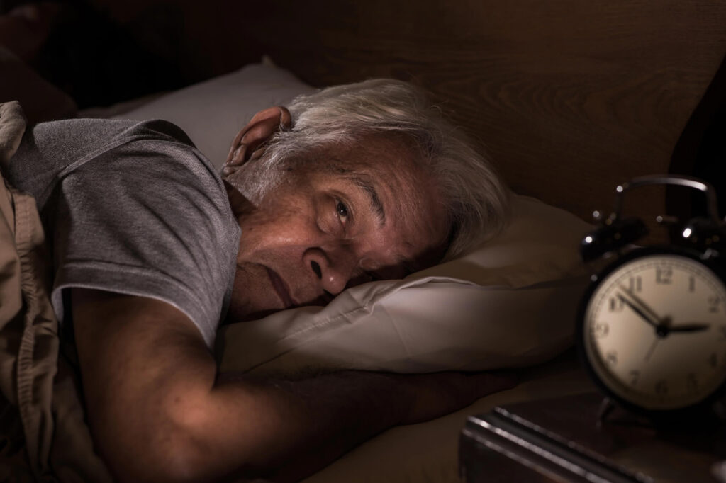 A tired business owner stares at the wall when he should be sleeping
