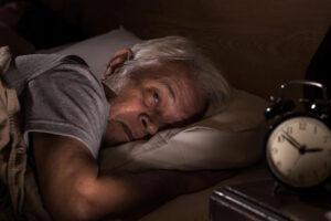 A tired business owner stares at the wall when he should be sleeping